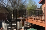 Small deck railing with curved stair case.